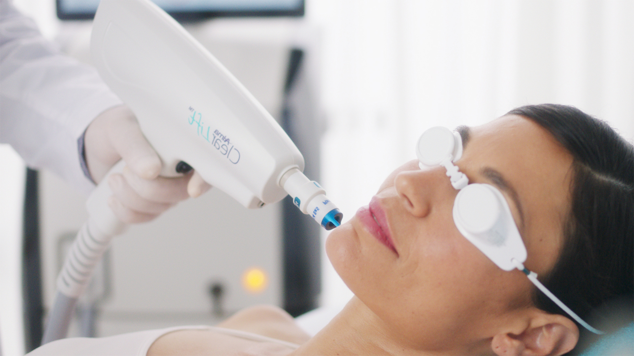 A woman with goggles on getting a clearlift treatment on her face