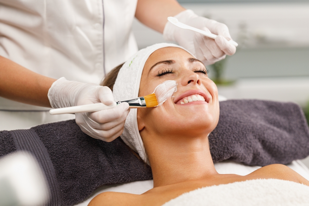 Woman receiving a facial at a spa